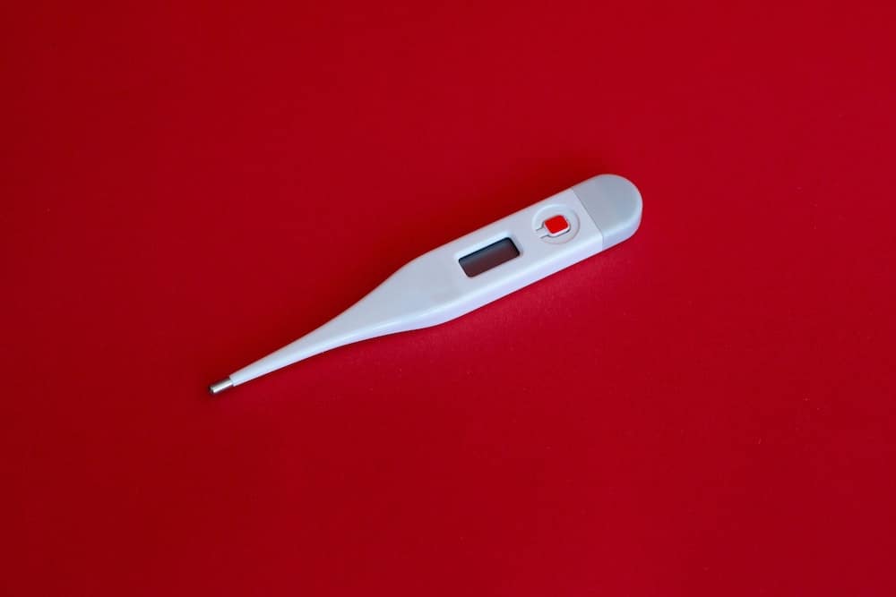 thermometer on red background - covid-19 flu season