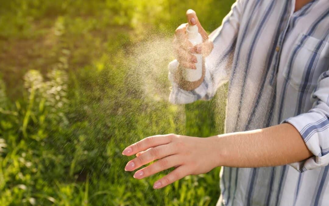 Woman spraying mist on her arm in good weather
